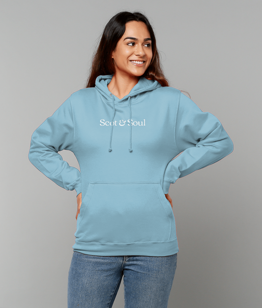 Woman wearing an ice blue hoodie with 'Scot & Soul' logo on a grey background